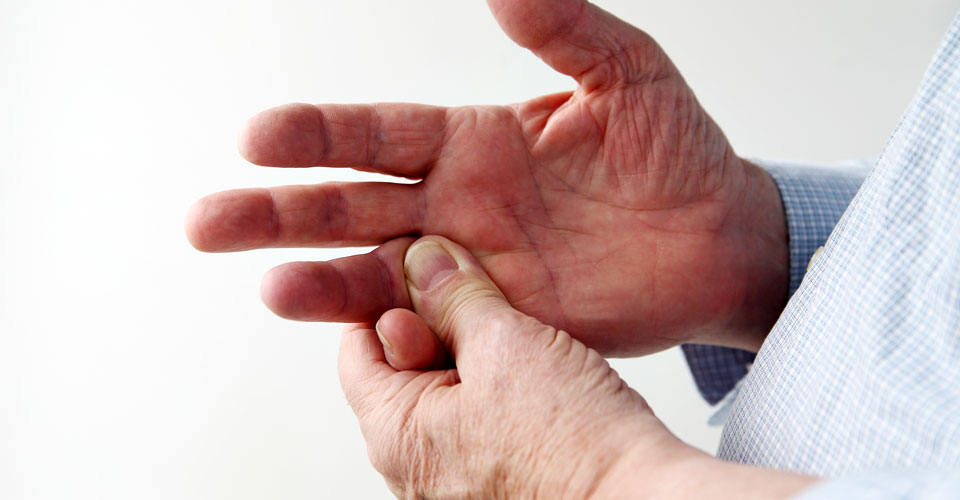 Man rubbing sore knuckle